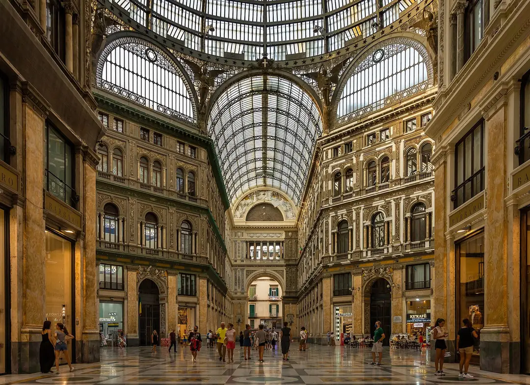 Glass-and-iron roof and ornate facades inside Galleria Umberto I in Naples