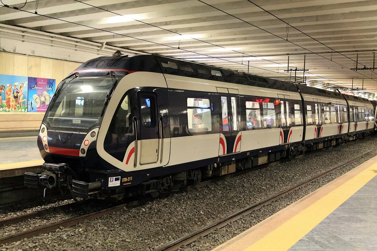 Red, white and black Circumvesuviana train at the platform of Napoli Garibaldi station