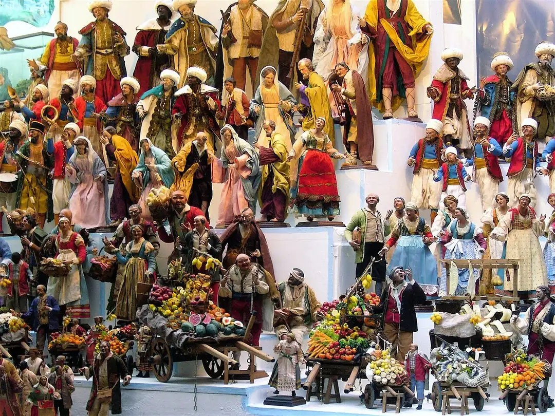 Crowded display of hand-painted nativity figures on a stall in Via San Gregorio Armeno