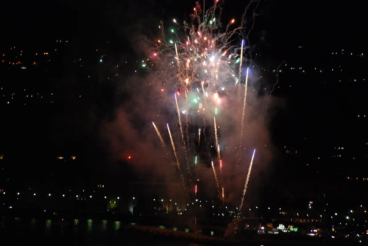 Fireworks bursting over the Mergellina waterfront in Naples at night