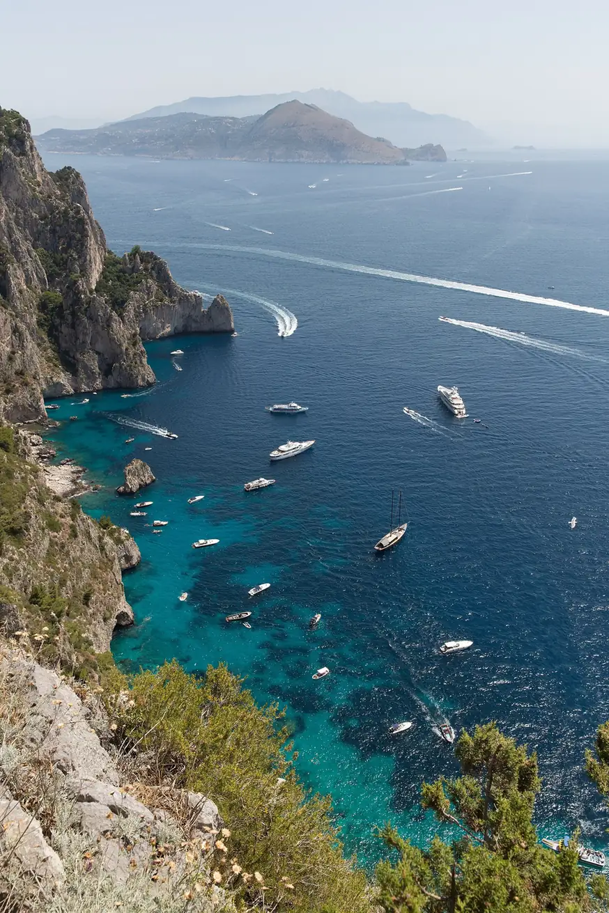 Tour boats off Capri's cliffs near the Blue Grotto entrance