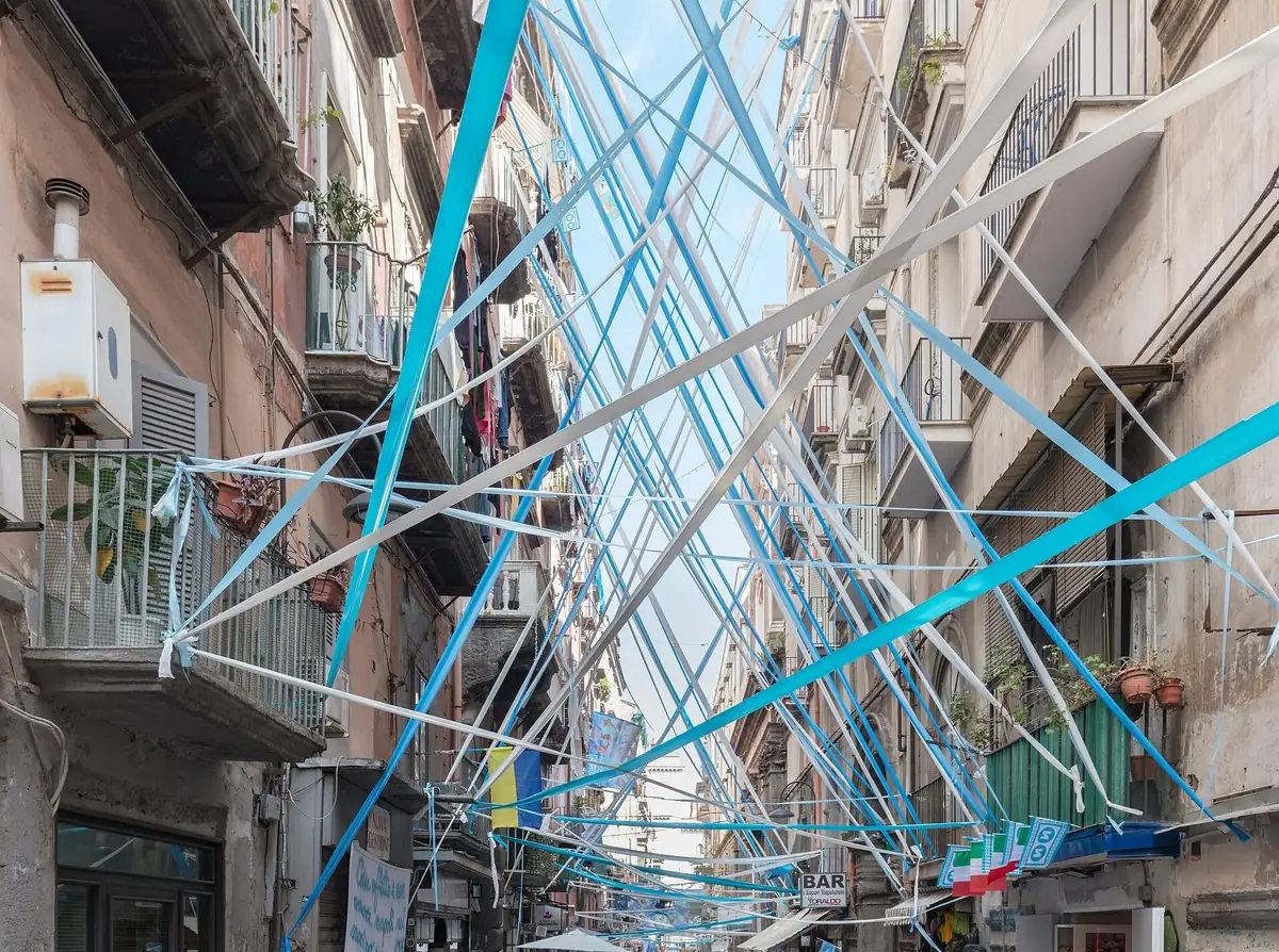 Via dei Tribunali hung with blue and white Napoli ribbons