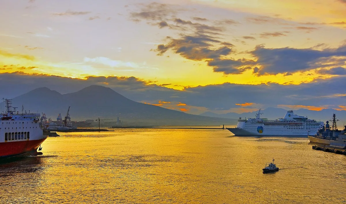 Golden dawn light over the port of Naples with Vesuvius behind