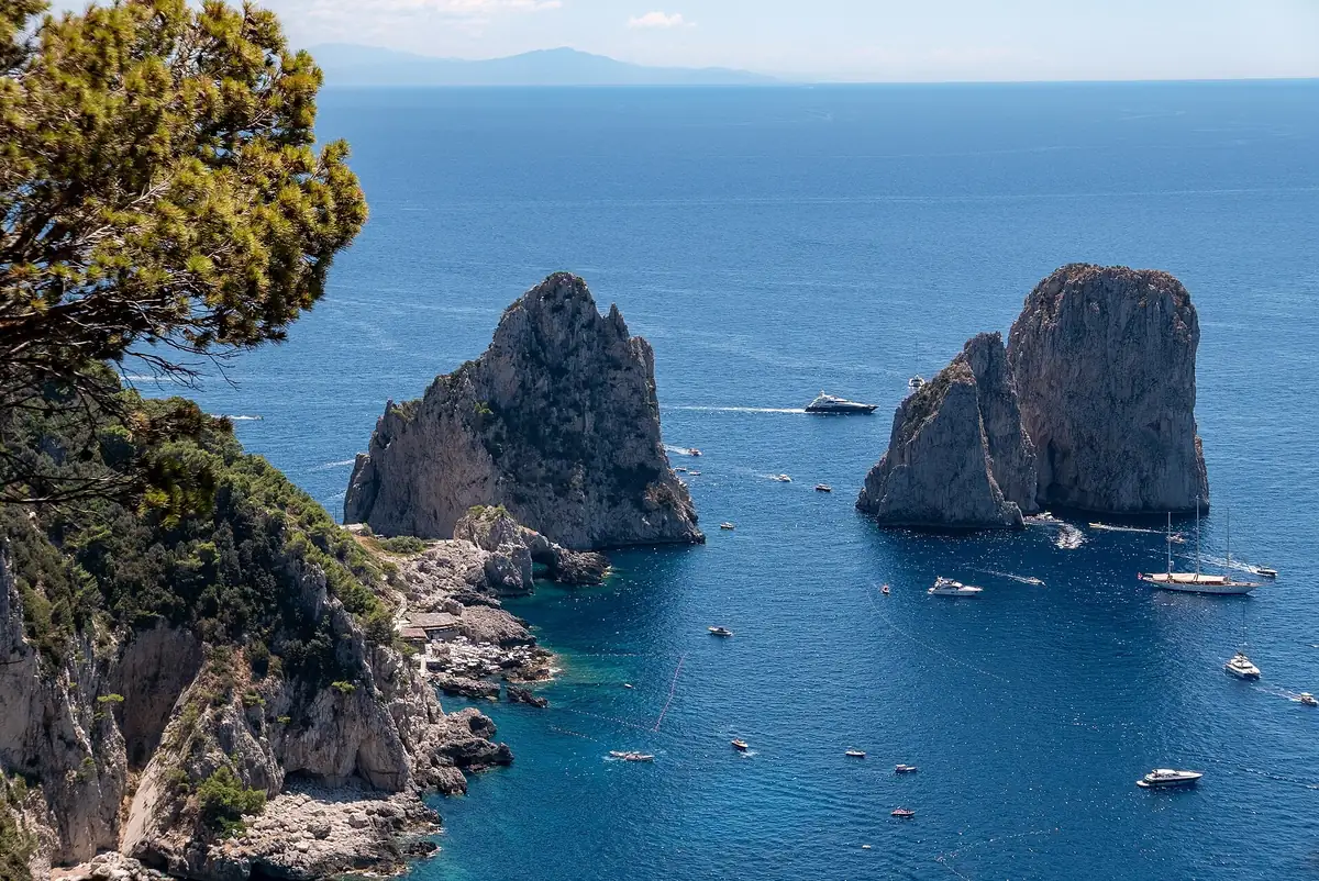 The Faraglioni off Capri's southern coast with boats around the rocks