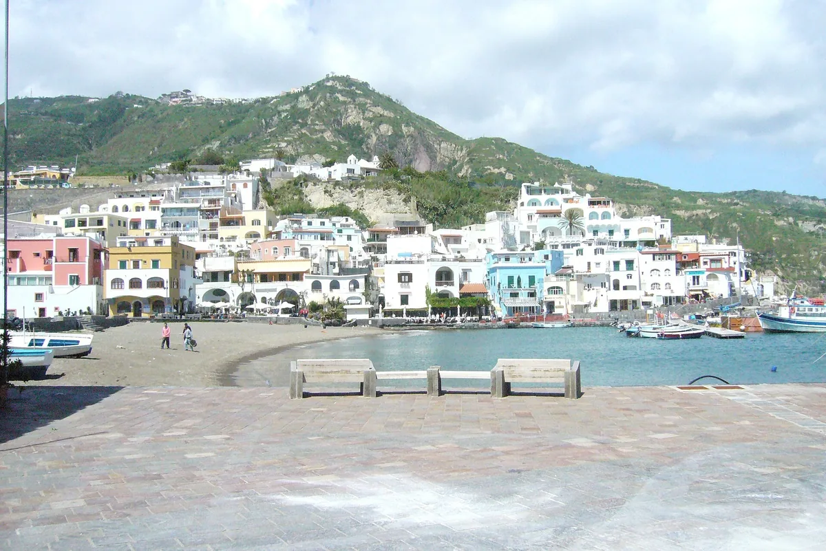 White houses of Sant'Angelo on Ischia's south coast below green hills